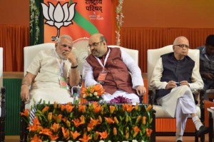 BJP President Amit Shah in consultation with Prime Minister Narendra Modi during the BJP National Council meeting in New Delhi on Aug. 9, 2014. (Photo: IANS)