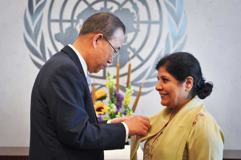 Shamshad Akhtar (R), Executive Secretary of the UN Economic and Social Commission for Asia and the Pacific, has a pin attached by UN Secretary-General Ban Ki-moon, during a swearing-in ceremony held at the UN headquarters in New York, on July 7, 2014. Shamshad Akhtar of Pakistan was appointed as the executive secretary of the United Nations Economic and Social Commission for Asia and the Pacific on December 10, 2013. 