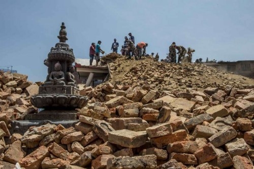 Soldiers and local people clear the debris of damaged buildings in Lalitpur, an ancient city adjacent to Kathmandu, capital of Nepal on May 12, 2015. Lalitpur was damaged seriously in last month's earthquake and following aftershocks.