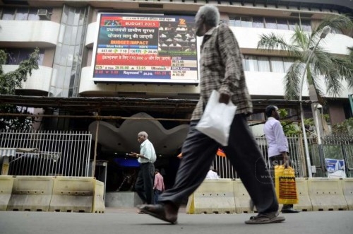 People watch Union Finance Minister Arun Jaitley present the national budget for 2015-16 on a big screen outside Bombay Stock Exchange in Mumbai on Feb 28, 2015. 