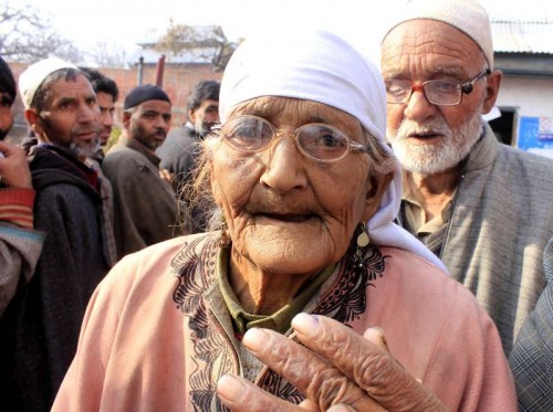  A 95-year old lady arrives at a polling booth to cast her vote during the third phase of Jammu and Kashmir polls