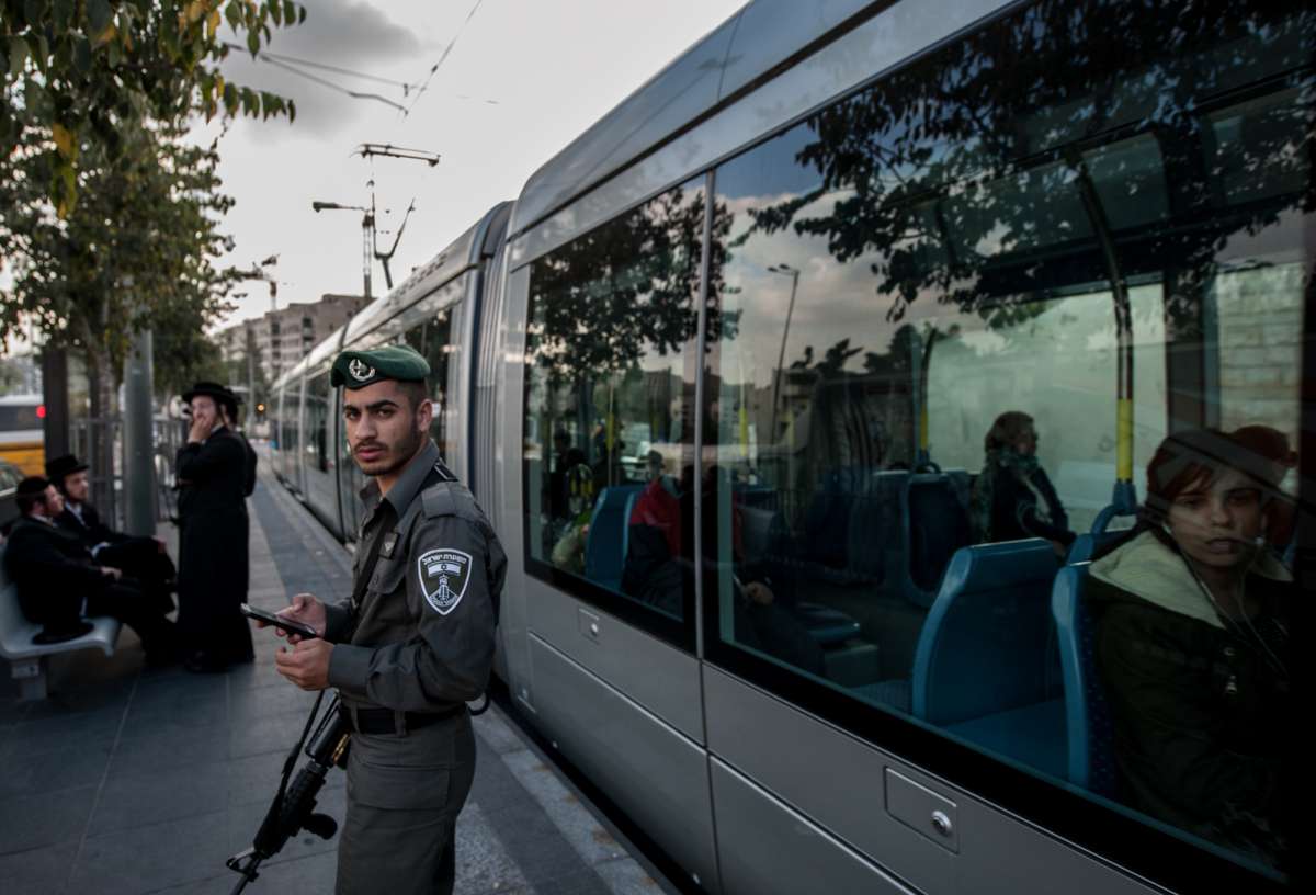 An Israeli border policeman stands guard at Shimon Hatzadik light rail station where an attack occurred in East Jerusalem, on Nov. 5, 2014. A Palestinian motorist rammed his van into pedestrians and then assaulted them with a metal bar in tension-ridden Jerusalem Wednesday, leaving one person dead and 13 others injured, before being shot dead by Israeli police. 