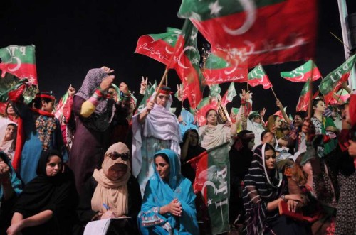 Supporters of Pakistan Tehrik-e-Insaf leader Imran Khan wave flags during an anti-government protest near the prime minister's residence in Islamabad, capital of Pakistan. Senior political leaders in Pakistan on Tuesday threw weight behind Prime Minister Nawaz Sharif, and condemned two opposition leaders for staging protesting sit-ins against the government that has disrupted life in capital Islamabad.