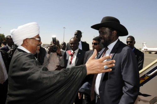 Sudanese President Omar al-Bashir greets South Sudan's President Salva Kiir at Khartoum's airport, Sudan, on Nov. 4, 2014. Sudan and South Sudan on Tuesday vowed to peacefully settle the outstanding issues, namely the security ones so that they would live side by side in peace and stability. 