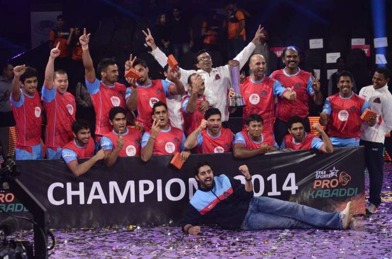 Jaipur Pink Panthers owner and Bollywood actor Abhishek Bachchan along with his team members celebrate after winning the finals of the Pro Kabaddi League against U Mumba in Mumbai on August 31, 2014. (Photo: IANS)