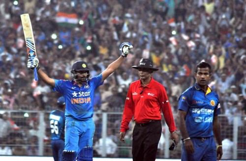 Indian batsman Rohit Sharma celebrates his double century during the 4th ODI between India and Sri Lanka at the Eden Gardens in Kolkata, on Nov 13, 2014. 