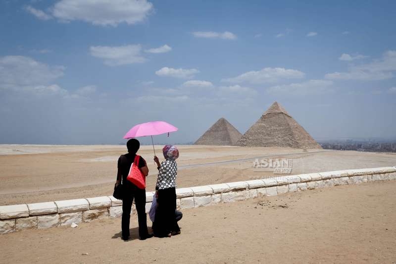 Tourists look at the Pyramids of Giza, Cairo, Egypt