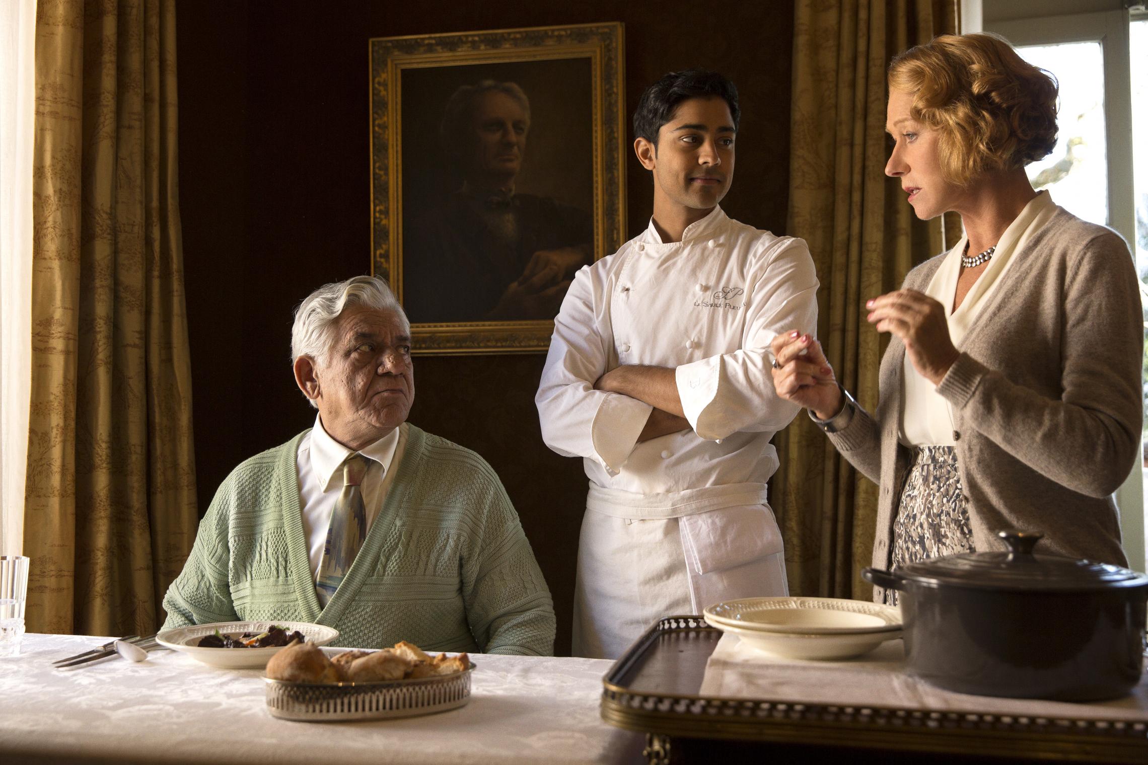 HFJ-0087r In DreamWorks Pictures' charming new film "The Hundred-Foot Journey," Hassan (MANISH DAYAL, center) serves his father (OM PURI) Beef Bourguinon á la Hassan, a classic French dish with an Indian twist, as Madame Mallory (HELEN MIRREN) explains its significance to French chefs. Photo: Francois Duhamel ©DreamWorks II Distribution Co., LLC. All Rights Reserved.