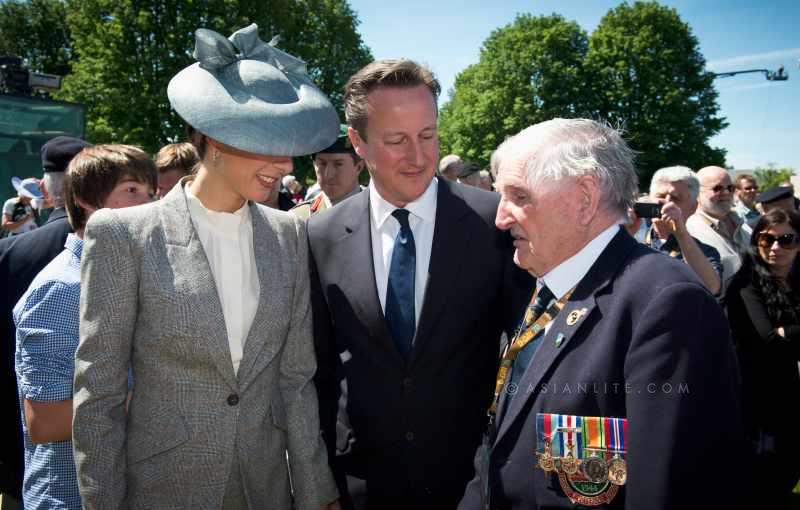 British Prime Minister David Cameron and wife Samantha with a war veteran during the D-Day events 