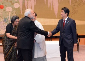 Prime Minister Narendra Modi (front L) shakes hands with Japanese Prime Minister Shinzo Abe during a signing ceremony to establish sister city ties between Kyoto and Varanasi in Kyoto, Japan