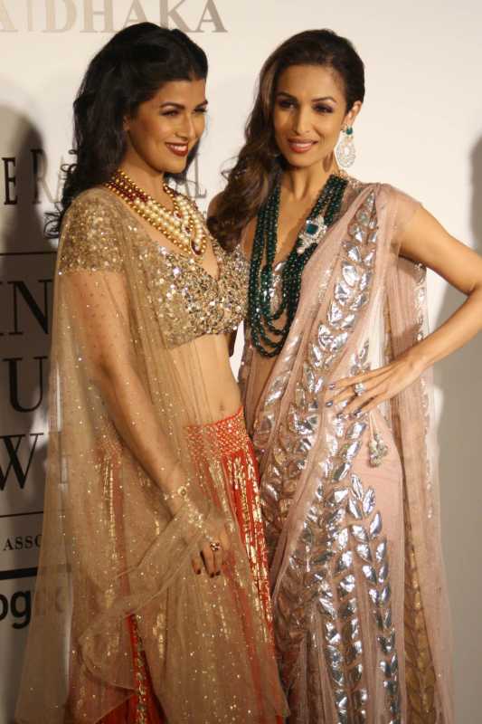 Bollywood actress Malaika Arora Khan and Nimrat Kaur pose for photos with a dress created by Indian designer Rina Dhaka at the India Couture Week 2014 in New Delhi, on July 16, 2014. (Photo: IANS/Amlan Paliwal)