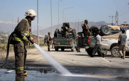 A firefighter cleans the site of blast in Kabul, Afghanistan, May 13, 2015. An explosion targeted a police vehicle in the Afghan capital of Kabul