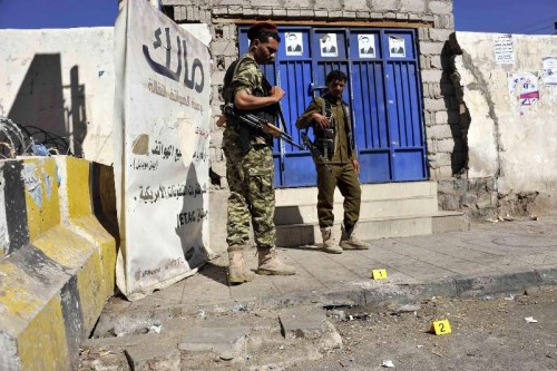 Houthi fighters guard the gate of the republican palace where a bomb went off and wounded three people, in Sanaa, Yemen, on Feb. 7, 2015. The Shiite Houthi group held a conference in the republican palace on Friday and announced its decision to form a presidential council and a national council to replace the presidency and parliament to run the country.