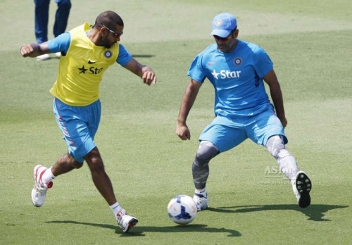 Indian captain M S Dhoni and Shikhar Dhawan in action during a practice session at Melbourne Cricket Ground (MCG)
