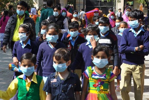 Children wear masks to protect themselves from swine flu in Jaipur, on Feb 18, 2015. 