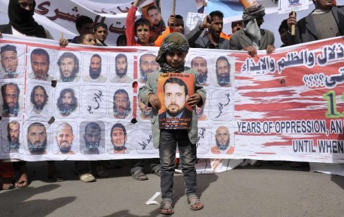 Relatives of Yemeni Guantanamo detainees hold pictures of the detainees during a rally demanding the release of them, outside the US embassy in Sanaa, Yemen Approximately 90 Yemeni nationals are currently detained in the U.S. prison in Guantanamo Bay in Cuba. 