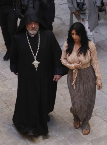 U.S. reality TV star Kim Kardashian (R) walks with a clergy at the Armenian Patriarchate of Jerusalem in the Old City of Jerusalem, on April 13, 2015. U.S. reality TV star Kim Kardashian and her rapper husband Kanye West were in Jerusalem's Old City Monday for the baptism of their daughter North West at the Armenian Cathedral. 