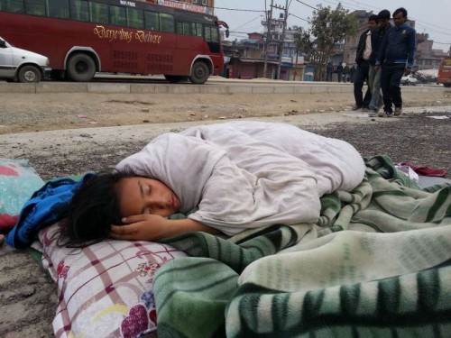 A little girl sleeps on road side in Kathmandu, Nepal, April 26, 2015. Death toll from Nepal earthquake surpasses 1,800, and over 4,700 people were injured, Home Minnistry of Nepal. 