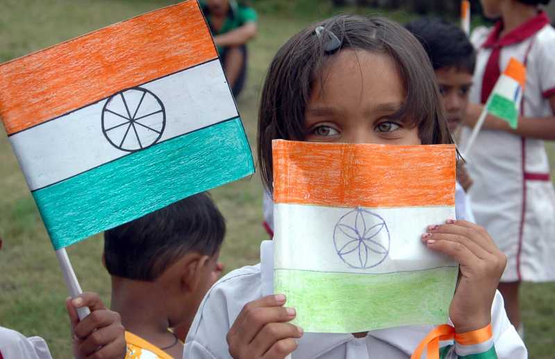 A child hold national flag as she celebrates Independence Day in Kolkata on Aug 15, 2014. (Photo: Kuntal Chakrabarty/IANS)