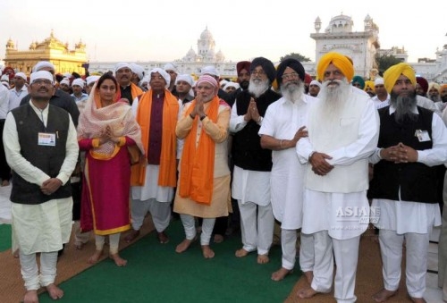  Prime Minister Narendra Modi pays obeisance at the Golden Temple, in Amritsar, Punjab on March 23, 2015. Al;so seen Punjab Chief Minister Parkash Singh Badal