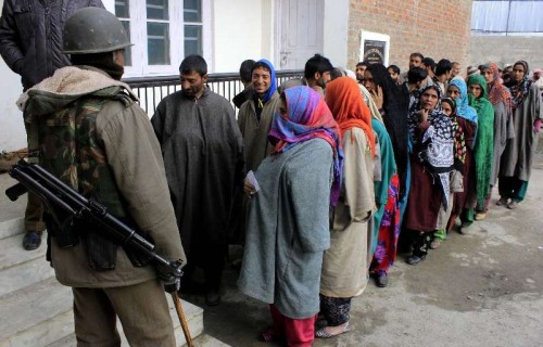 People wait in a queue to cast their votes at a polling station at Harikanwan Village in district Ganderbal of Jammu and Kashmir on Nov. 25, 2014.