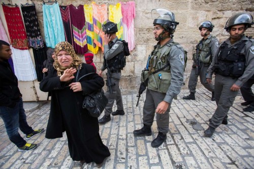 Palestinian women stand next to Israeli border police near a barrier leading to the Al-Aqsa Mosque near lions gate in Jerusalem's Old City, on Nov. 2, 2014. Israeli Prime Minister Benjamin Netanyahu called on Sunday to the Israeli right-wing Knesset members to show restraint in regard to the Jewish presence in the Al-Aqsa Mosque or the Temple Mount compound.