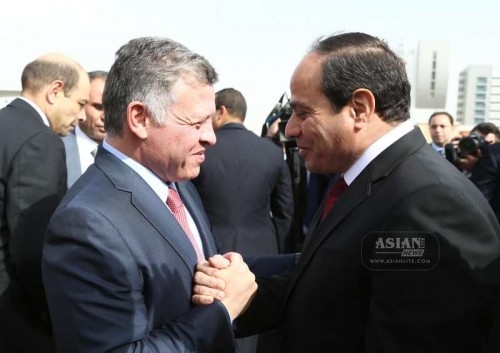 The handout photo from Egypt's state-run news agency MENA shows that Egyptian President Abdel Fattah al-Sisi shakes hands with the visiting Jordan's King Abdullah II upon his arrival to Cairo for talks on terms of anti-terrorism, cooperation in military and security