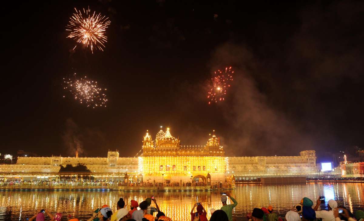 Amritsar: Fire works light up the sky above the Golden Temple on Guru Nanak Jayanti in Amritsar on Oct. 23, 2014. (Photo: IANS)