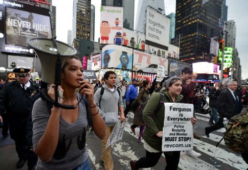 People take part in a protest in New York, the United States, on Dec. 1, 2014. Demonstrations continue over a grand jury's decision last week not to charge police officer Darren Wilson who fatally shot unarmed 18-year-old Michael Brown in Ferguson, Missouri.