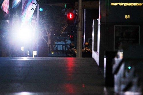 Policemen secure Martin Place in Sydney, Australia, on Dec. 15, 2014. A gunman, who held an unknown number of people hostage in a downtown cafe in Martin Place of Sydney on Monday, has been identified after five hostages managed to flee the hours-long siege.