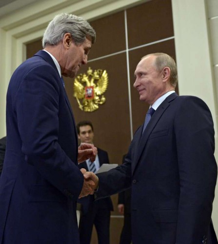 Russian President Vladimir Putin (R) shakes hands with U.S. Secretary of State John Kerry during their meeting in Sochi, Russia, May 12, 2015.