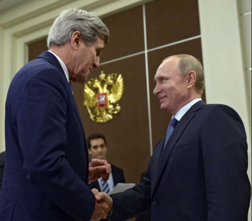 Russian President Vladimir Putin (R) shakes hands with U.S. Secretary of State John Kerry during their meeting in Sochi, Russia, May 12, 2015.