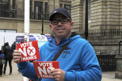 A man shows signs of opposing Scotland's independence, in Edinburgh, Britain, Sept. 17, 2014. The Scottish Independence Referendum will take place here on September 18