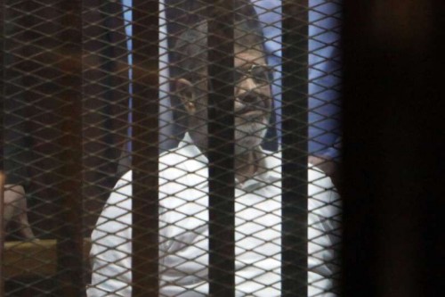 Egypt's ousted President Mohamed Morsi sits inside the defendants' cage at a court in Cairo, Egypt, on April 21, 2015. An Egyptian Court on Tuesday sentenced former Islamist President Mohammed Morsi to 20 years in prison over the killing of protesters in 2012.