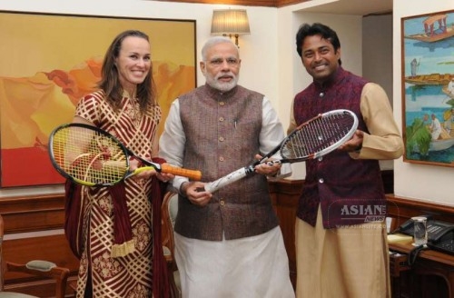 Tennis Players Martina Hingis and Leander Paes present autographed racquets which they used during the Aus Open Mixed Doubles Finals to Prime Minister Narendra Modi, in New Delhi on March 5, 2015.