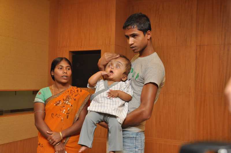 Roona who was suffering from hydrocephalus with her parents after second round of treatment where surgeons performed remodeling on the anterior part of her skull to further reduce and reshape her head which was three times larger than a normal child of her age at a private hospital in New Delhi 