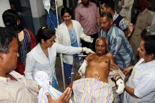 An elderly person, injured during cross border firing at RS Pora sector of Jammu, being wheeled into a Jammu hospital for treatment, on Oct.8, 2014. Twenty people were injured in overnight Pakistani firing at the border in Jammu and Kashmir.