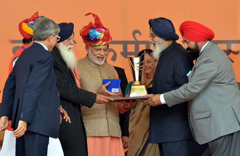  Prime Minister Narendra Modi at the launch of the `Soil Health Card scheme`, at Suratgarh, in Rajasthan on Feb 19, 2015. Also seen Chief Minister of Rajasthan Vasundhara Raje Scindia, Punjab Chief Minister Parkash Singh Badal and other dignitaries.