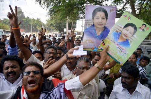 Supporters of AIADMK supremo and former Tamil Nadu Chief Minister J Jayalalithaa gather at Karnataka High Court during a hearing of the Rs.66-crore disproportionate assets case against their leader in Bangalore, on Sept. 30, 2014. The criminal revision petition of the jailed leader for suspension of her sentence and bail was Tuesday (30th September 2014) adjourned to Oct 6 by the judge of a vacation bench of the court. (Photo: IANS)