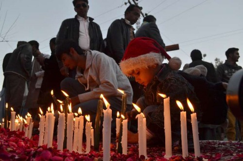  Pakistani Christians light candles to pay their respect to victims of the militant attack on an army-run school, in southwest Pakistan's Quetta, Dec. 19, 2014. At least 141 people, mostly children, were killed by Taliban terrorists who attacked the army-run school in Pakistan's northwestern provincial capital of Peshawar on Dec. 16.