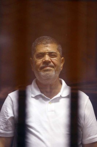  The deposed Islamist president Mohamed Morsi is seen inside a glass defendants cage during his trial in Cairo