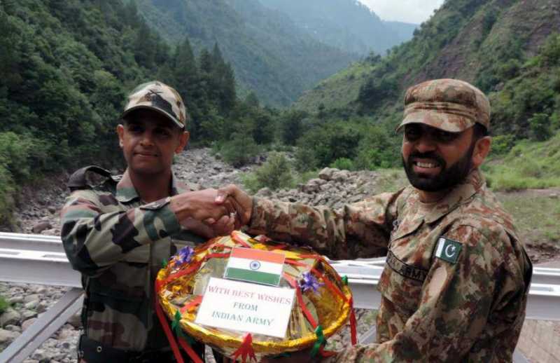 Indian and Pakistani troops deployed at Kaman Aman Setu and Tithwal celebrated Eid-ul-Fitr by exchanging sweets. In a brief ceremony, organized at Kaman Aman Setu at Uri and Tithwal at Tangdhar Jammu and Kashmir"s of Kupwara District, both Indian and Pakistani Armed Forces deployed on line of control greeted each other on the occasion of Eid-ul-Fitr and also exchanged sweets and pleasantries on July 29, 2014. (Photo: IANS)