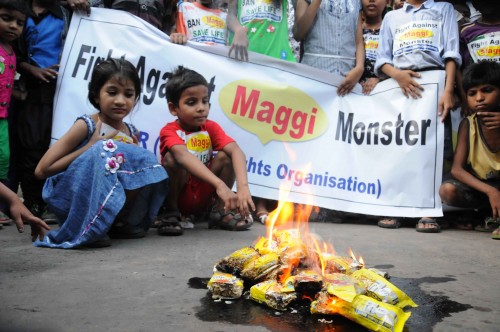  People burn Maggi packets in Kolkata on June 4, 2015. Maggi has been banned in several states after samples of the noodles were found to contain more than the permissible quantity of lead. (Photo: IANS)
