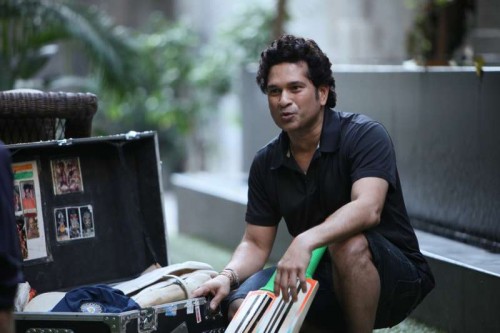 Cricket legend Sachin Tendulkar displays his treasured personal belongings to director James Erskine during the shoot of his Docu-feature film in Mumbai.