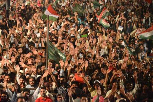 Supporters of religious leader Tahir-ul-Qadri raise up hands during an anti-government protest  