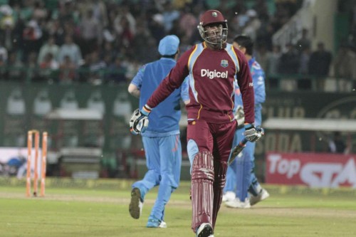 Dharmasala: West Indian players Andre Russell walks back to the pavilion after getting dismissed during the fourth ODI match between India and West Indies at Himachal Pradesh Cricket Association Stadium, Dharmasala on Oct.17, 2014. 