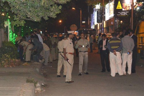  Policemen the site of the low intensity bomb blast that rocked Church Street area of Bengaluru on Dec 28, 2014. Two people, including a woman, were injured in the blast near a food outlet in the city centre. 