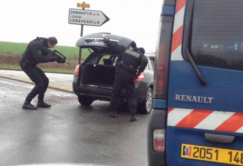 Policemen check a car in Dammartin-en-Goele, northeast of Paris, where two brothers suspected of Charlie Hebdo attack held one person hostage as police cornered the gunmen, on Jan. 9, 2015. The Kouachi brothers, suspects of Charlie Hebdo attacks, were killed during French security force's assault on Friday evening, and the hostages are alive. 