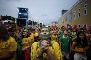 Brazilian Fans react while watching the game between Brazil and Cameroon in the FIFA Fan Fest in Recife, Brazil