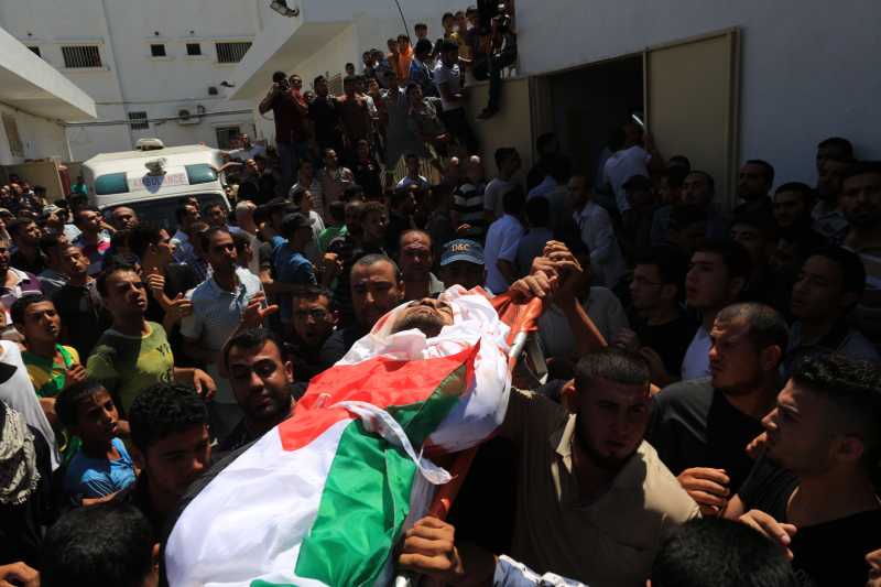  Palestinians carry the body of a member of a Hamad family during their funeral in the northern Gaza Strip town of Beit Hanun, on July 9 2014. Six members of a Hamad family were killed after an Israeli strike targeted their house in northern Gaza, medics said, on the second day of the Israeli operation against Palestinian militants. The Israeli air force bombed 160 targets in the Gaza Strip overnight as it pressed a wide scale campaign to stop volleys of Palestinian rocket fire, an army official said. At least 27 people were killed since the beginning of the Israeli attacks in the enclave.